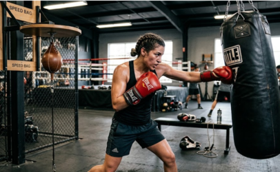 Athlete punching heavy boxing bag.